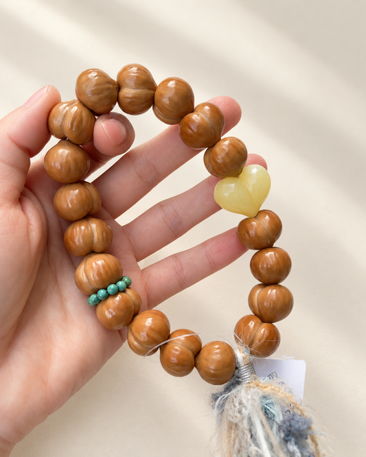 Monkey Head Walnut Hand Strand, Peach Beads — another angle