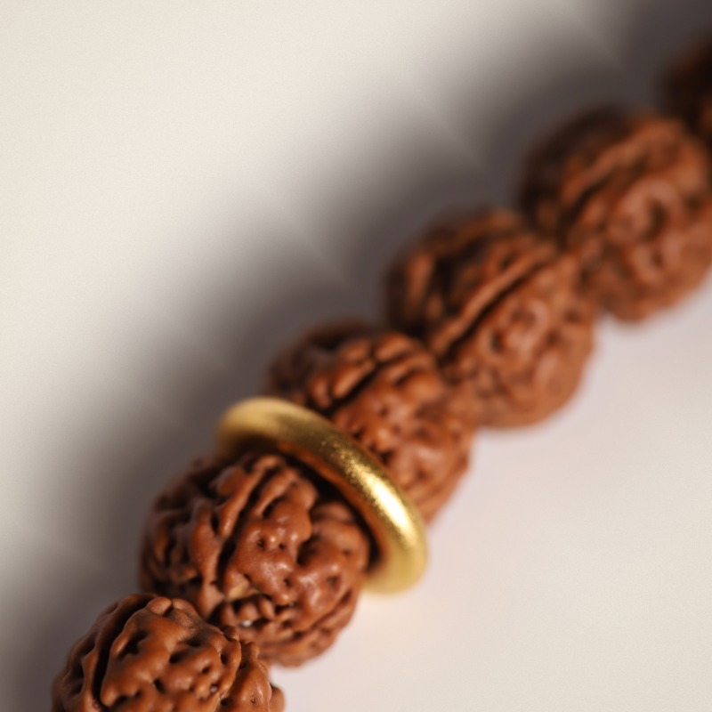 Rudraksha Strand, Natural Ridges — Selection Zero — bead ridges and gold spacer macro
