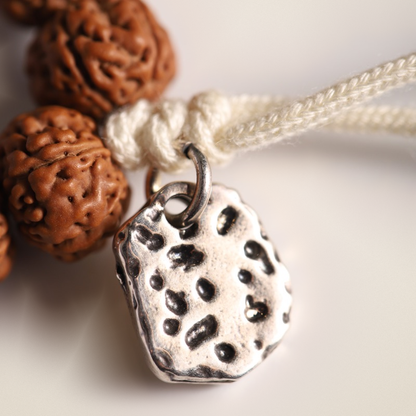 Rudraksha Strand, Natural Ridges — Selection Zero — metal tag and cord macro