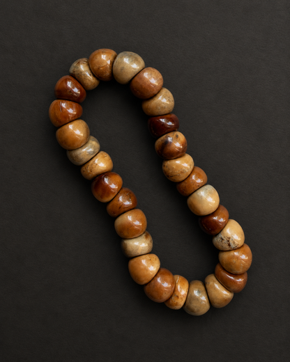 Kuke bracelet with natural swirl patterns on a charcoal surface