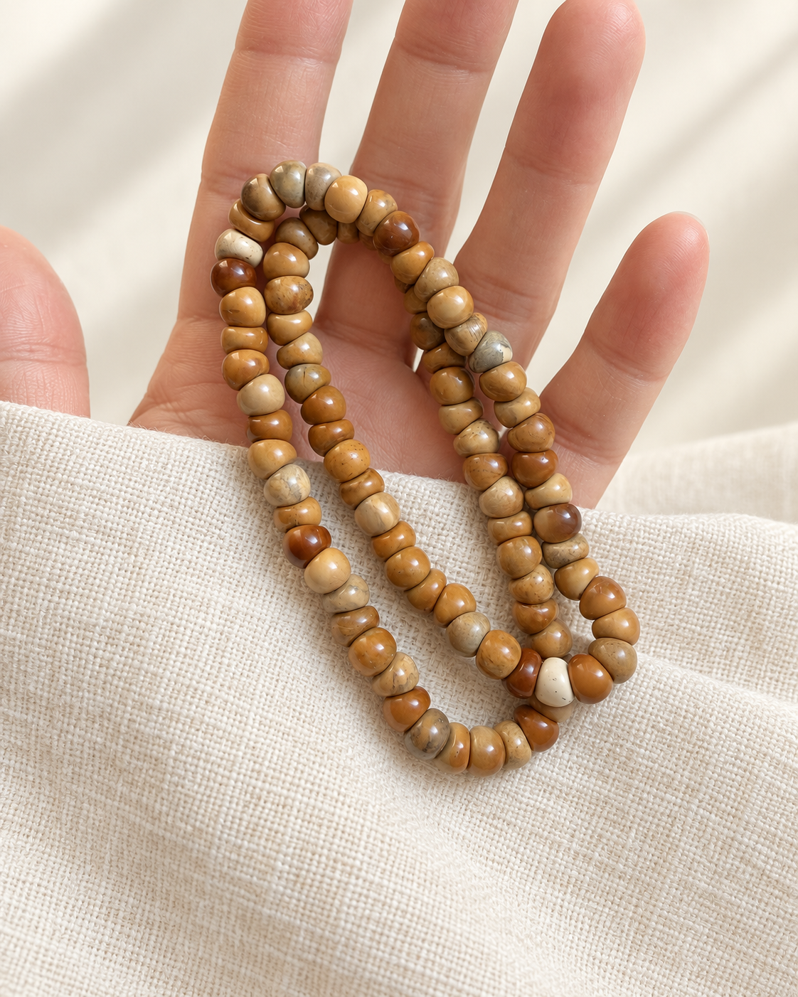 Smaller kuke beads arranged across the hand