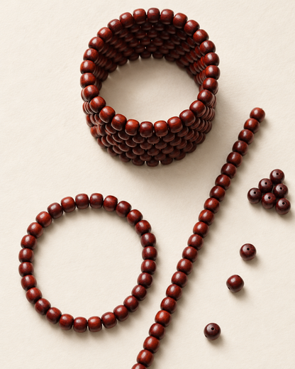 Zitan bead coil, bracelet and straight strand on an ivory surface